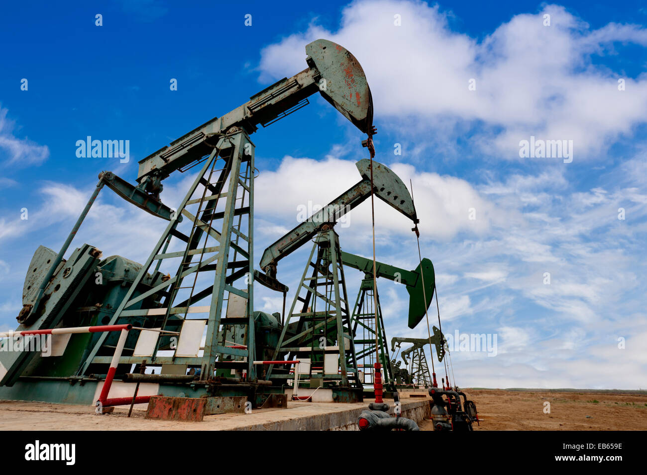 Working oil pump jacks on a oil field Stock Photo