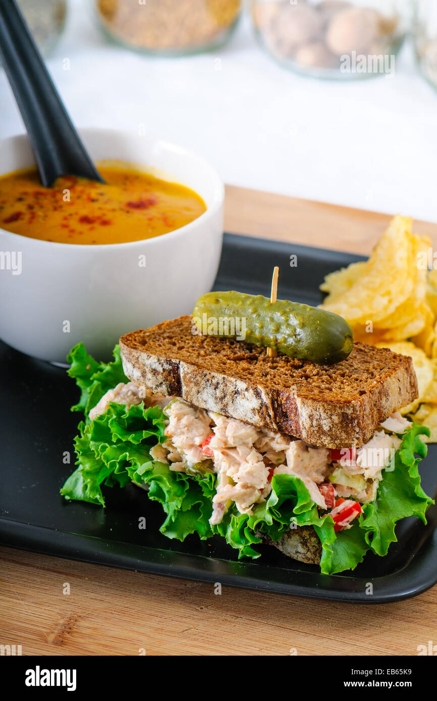 Tuna salad sandwich with lettuce on rye toast with butternut squash