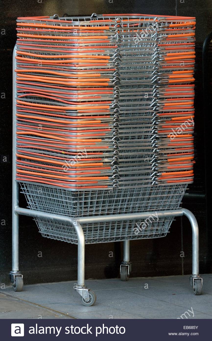 Stack of shopping baskets in a wheeled holder outside Sainsbury's Stock