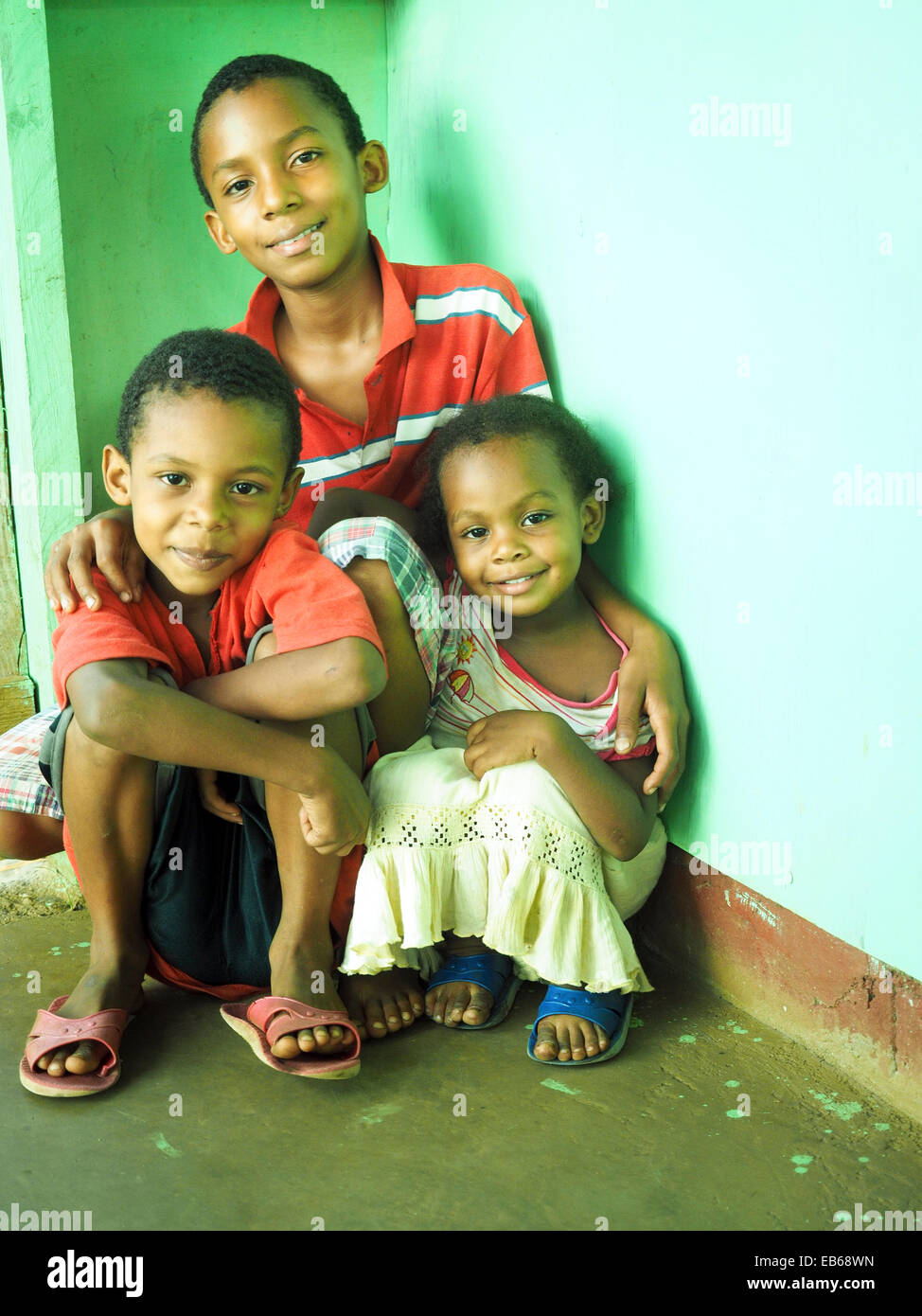 Portrait three happy young Nicaragua brothers sister family Corn Island love loving Nicaraguan Central America siblings little s Stock Photo