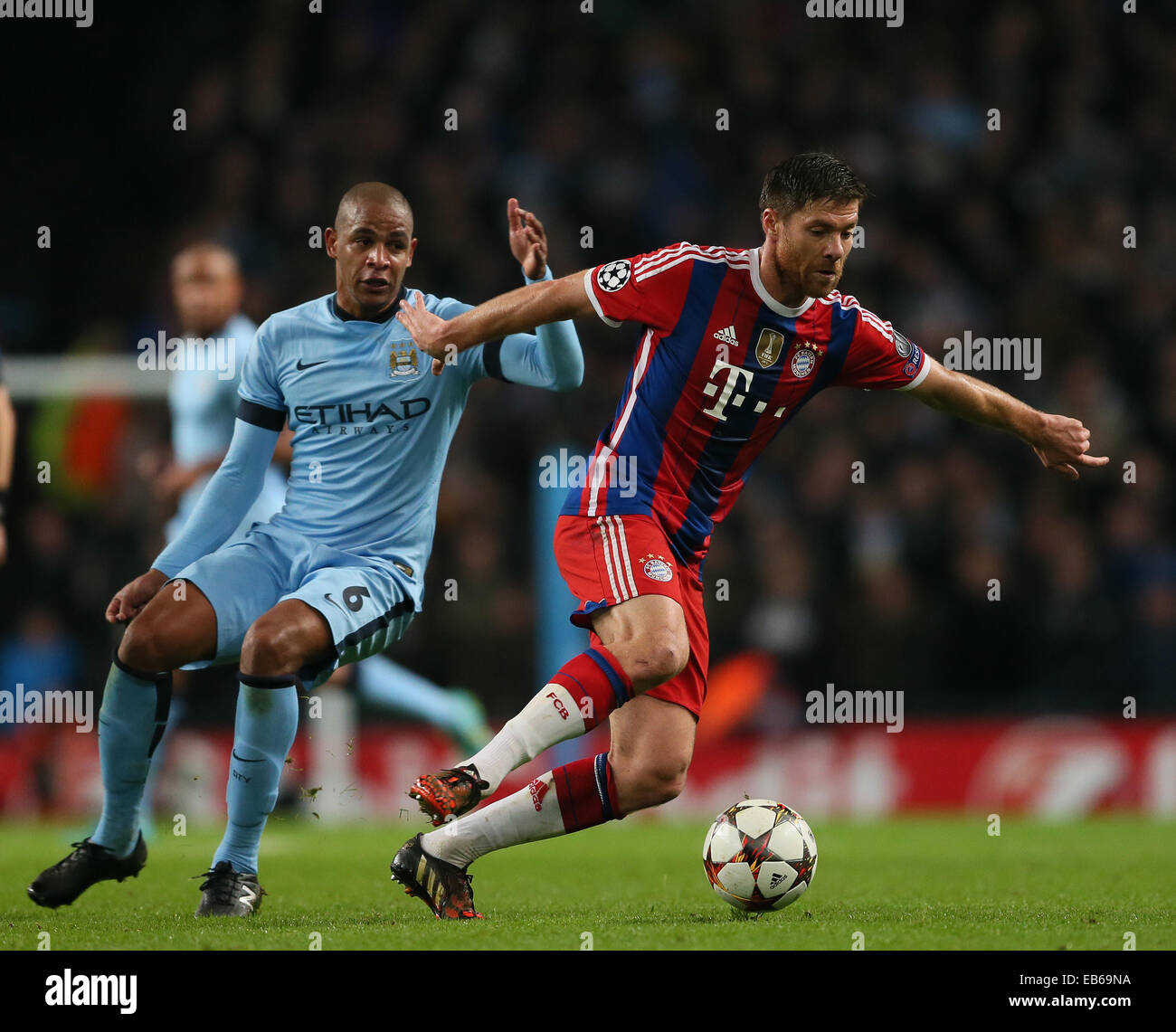 Nov. 25, 2014 - Manchester, United Kingdom - Fernando of Manchester City and Xabi Alonso of Bayern Munich - UEFA Champions League group E - Manchester City vs Bayern Munich - Etihad Stadium - Manchester - England - 25rd November 2014 - Picture Simon Bellis/Sportimage. Stock Photo
