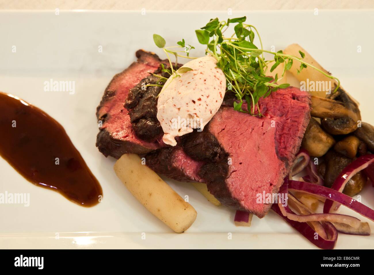 Oven baked deer tenderloin with cinnamon sauce Served with salsify and