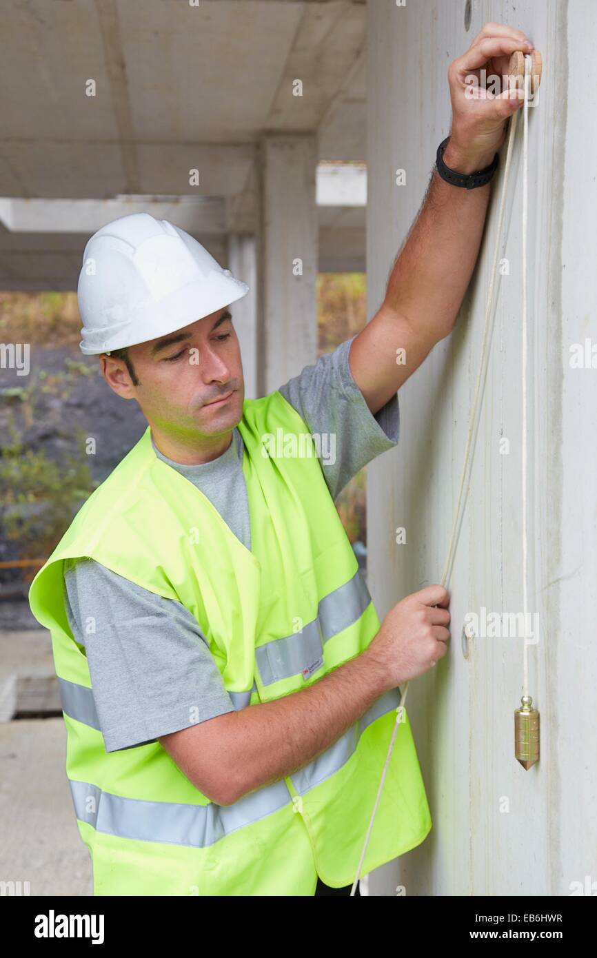 Worker with protective equipment PPE Checking and aligning vertical
