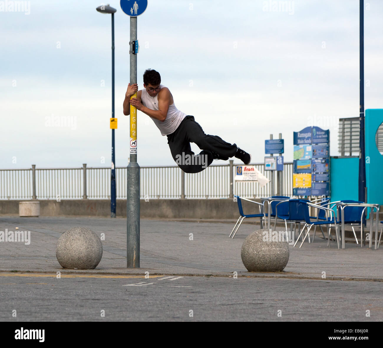 A young man practising Parkour moves at Ramsgate Harbour, Kent. Stock Photo