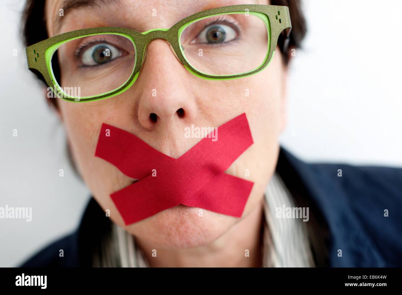 Woman with tape over mouth Stock Photo Alamy