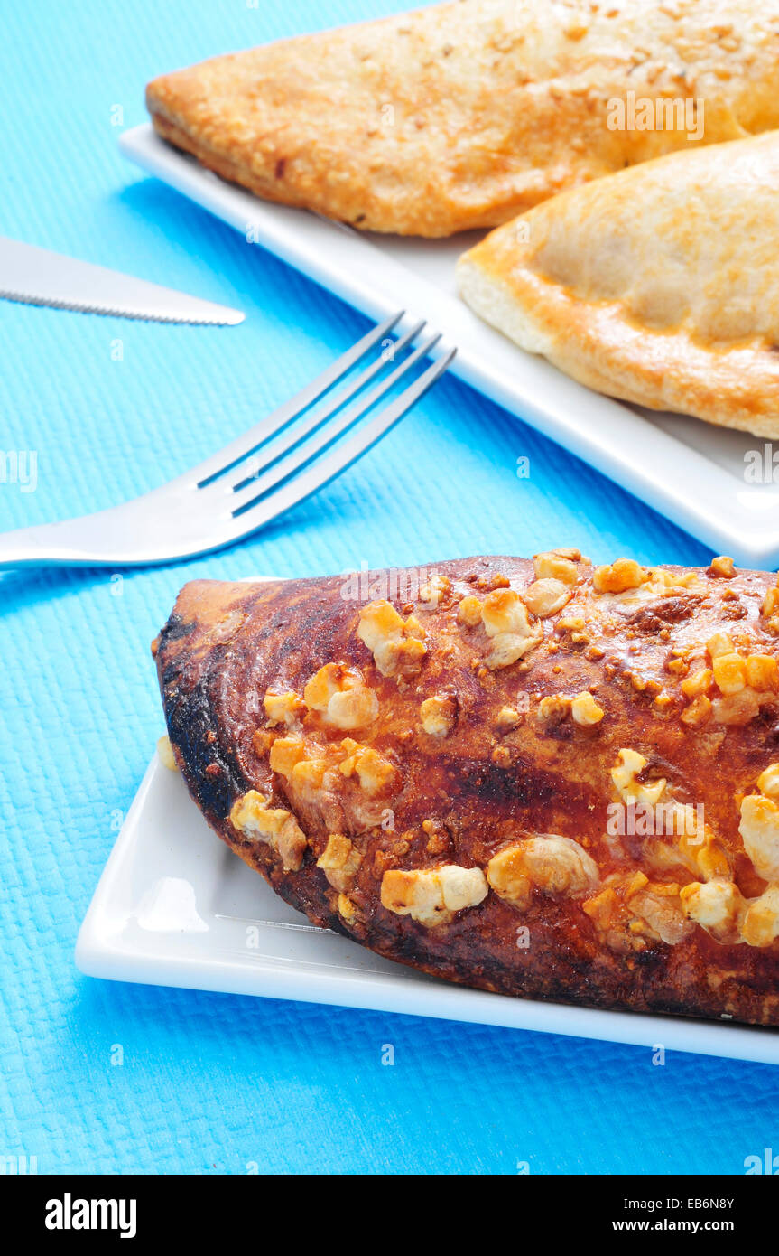 closeup of some different empanadas argentinas, typical argentine stuffed pastries, on a set table Stock Photo