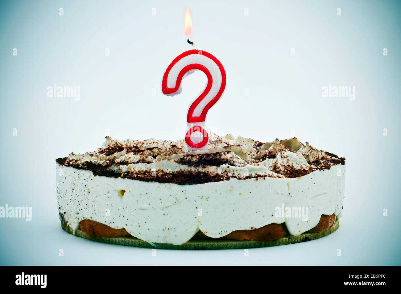 a birthday cake with a question mark shaped candle Stock Photo Alamy
