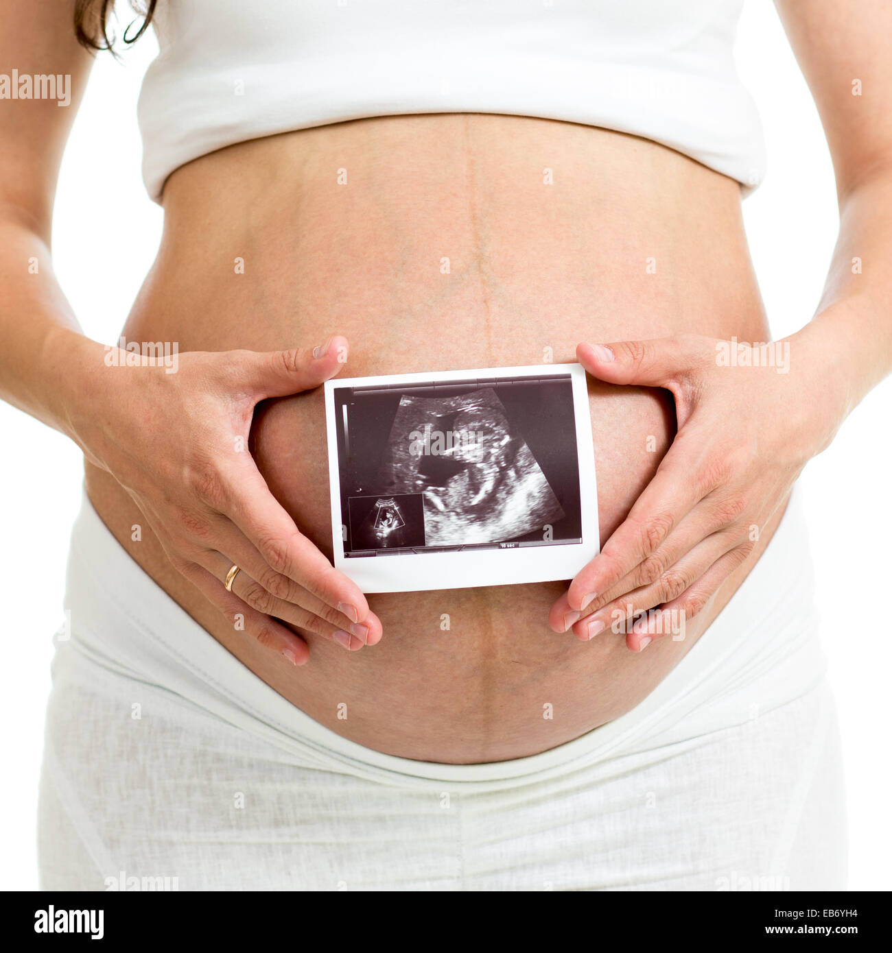 pregnant woman holding ultrasound sonogram of unborn baby Stock Photo