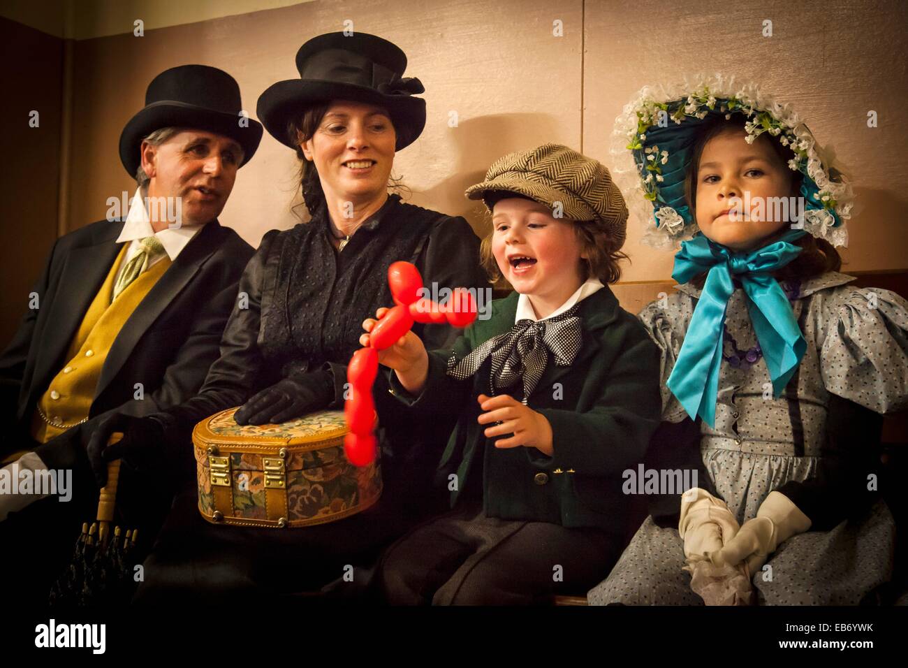 Family in Victorian dress watch sone play with balloon, Victorian festival, historic precinct, Oamaru, Otago Stock Photo