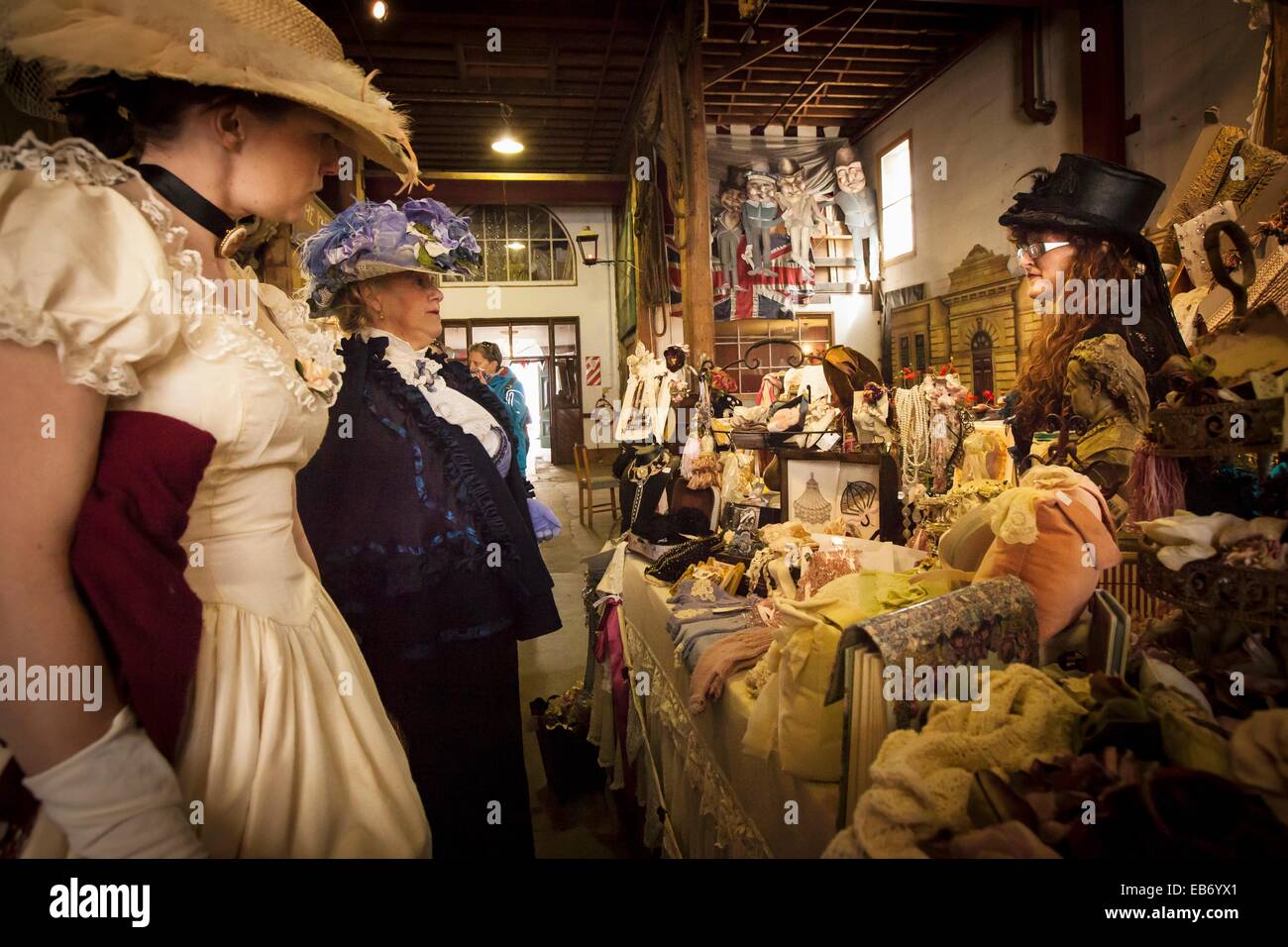 Ladies in Victorian dress browse in bric-a-brac shop, Victorian festival, historic precinct, Oamaru, Otago Stock Photo