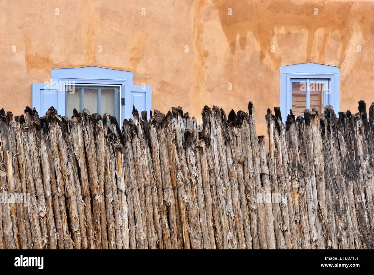 Adobe walls with coyote fencing in residential Santa Fe, Santa Fe, New