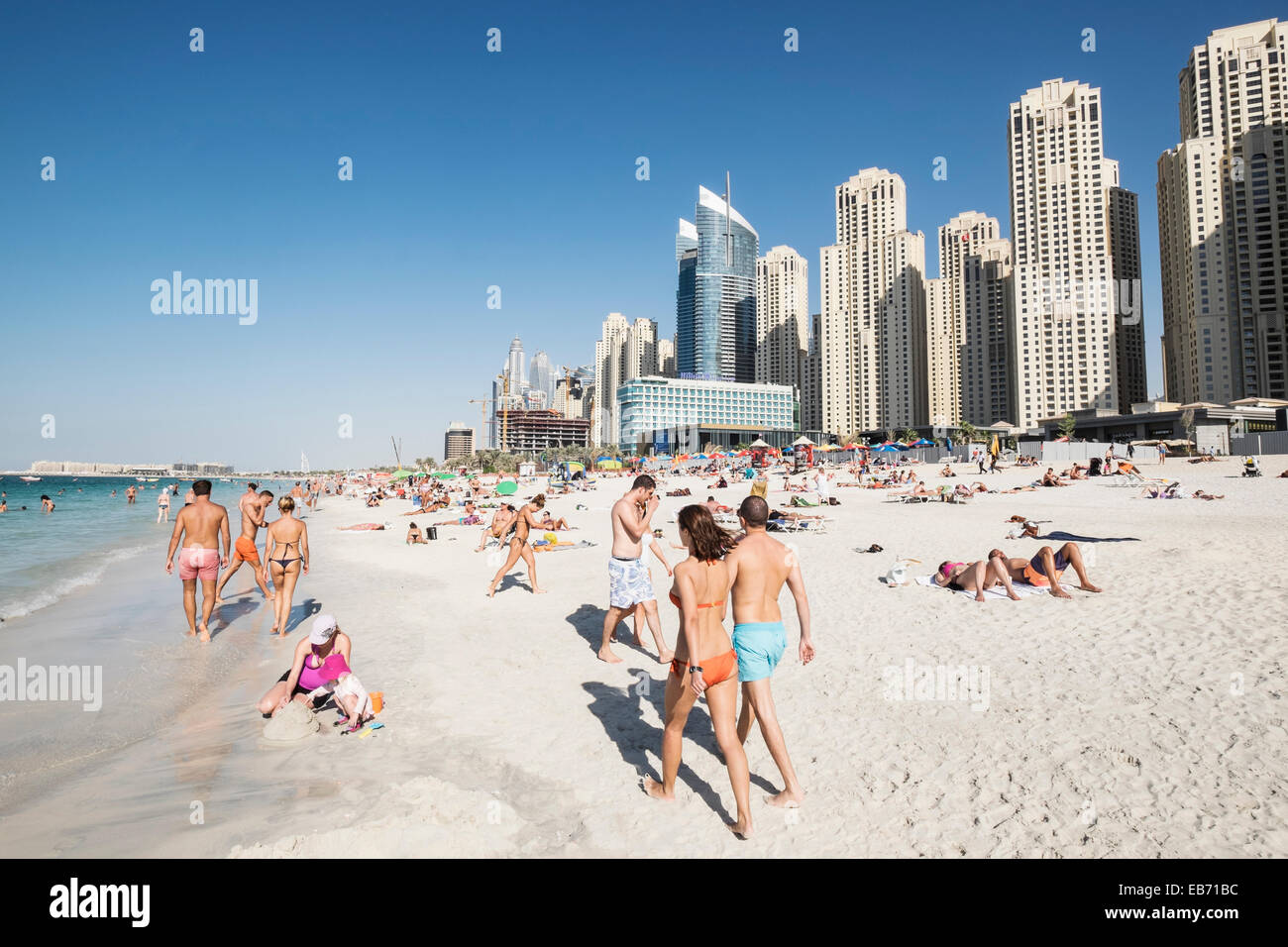 Busy public beach at Jumeirah Beach Resort (JBR) at Marina District in Dubai United Arab Emirates Stock Photo