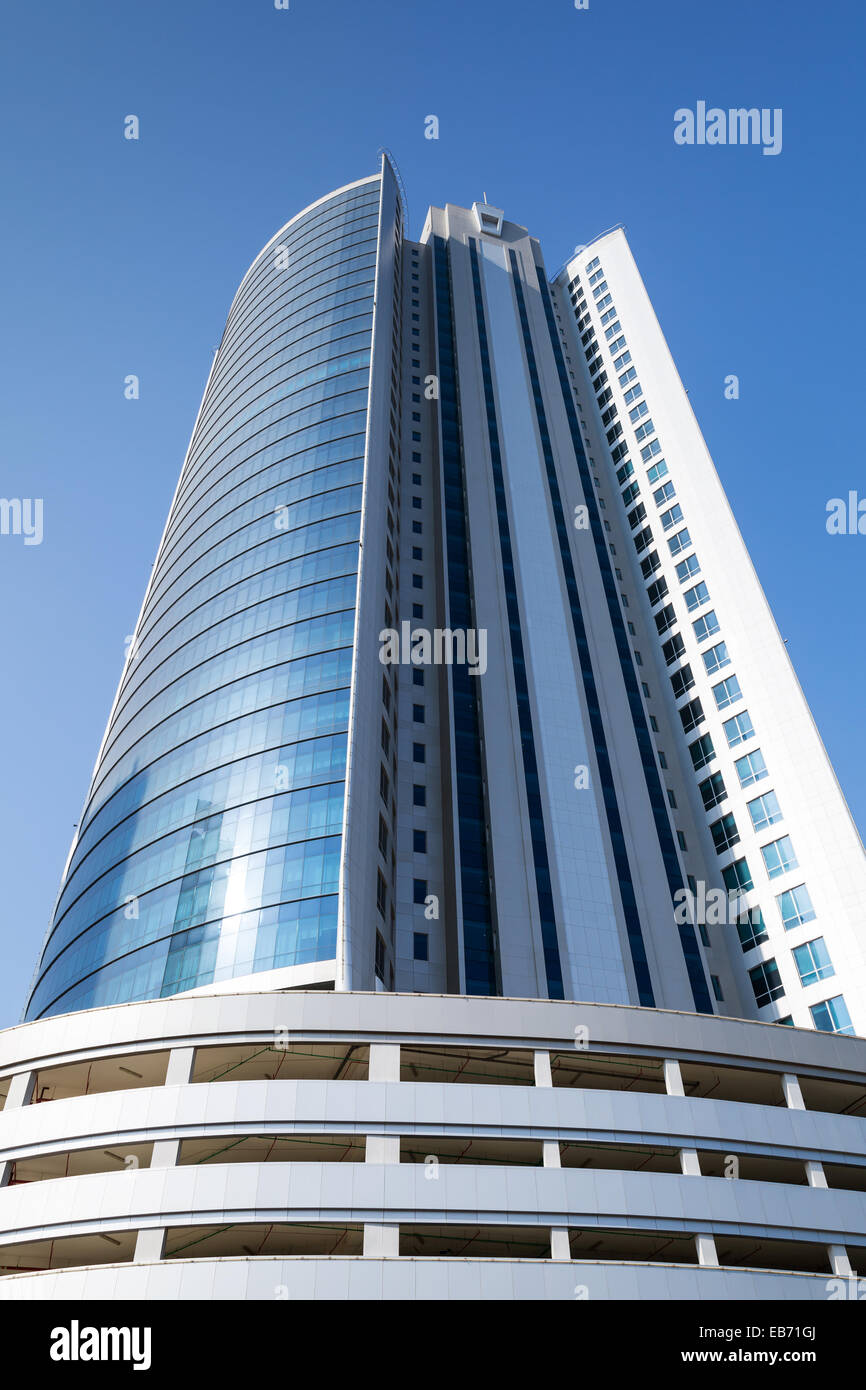 Manama, Bahrain - November 21, 2014: Diplomat Commercial Office Tower in Manama city. Shining scyscrapper on blue sky background Stock Photo