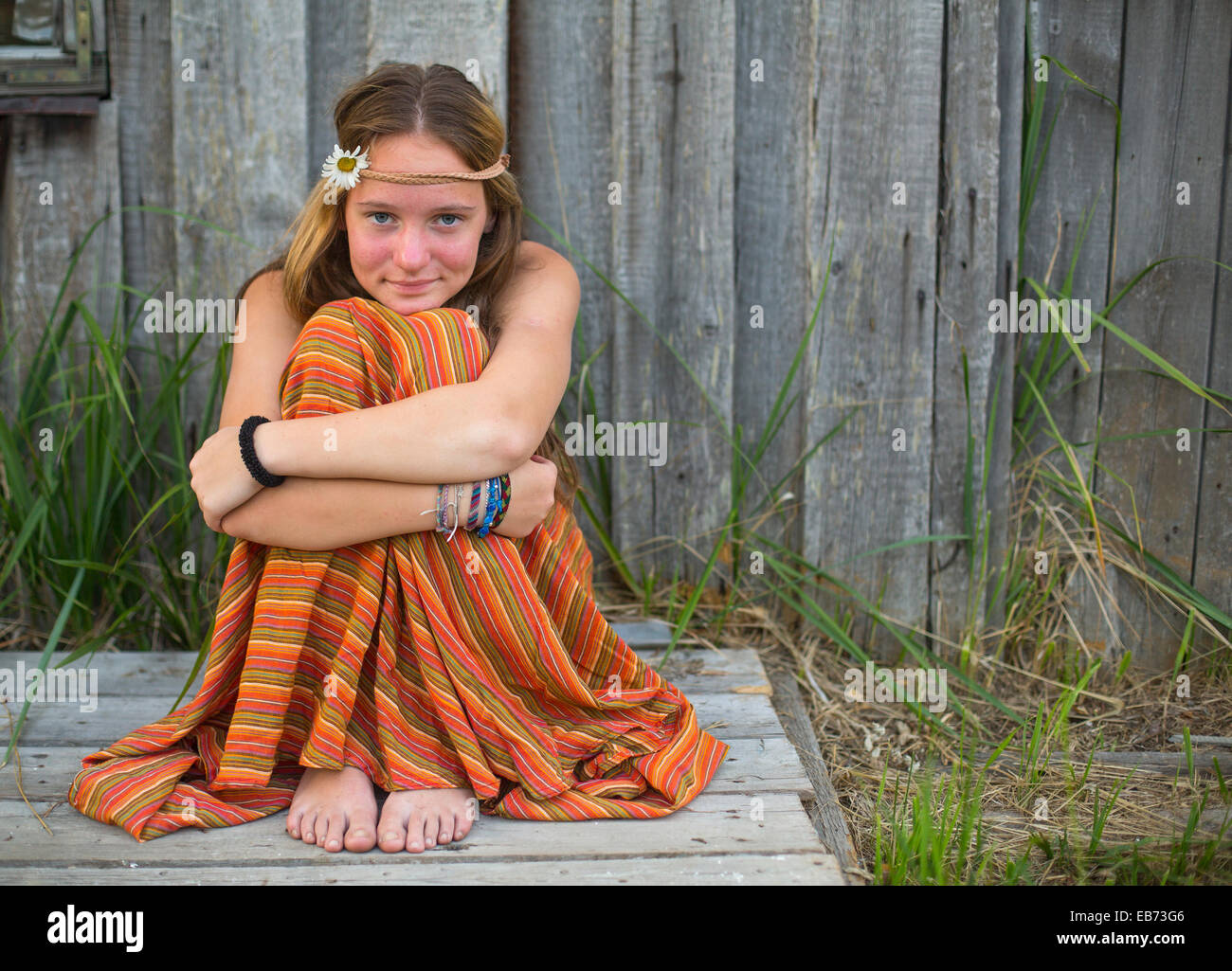 Young cute girl hippie sitting outdoors in the countryside Stock Photo ...
