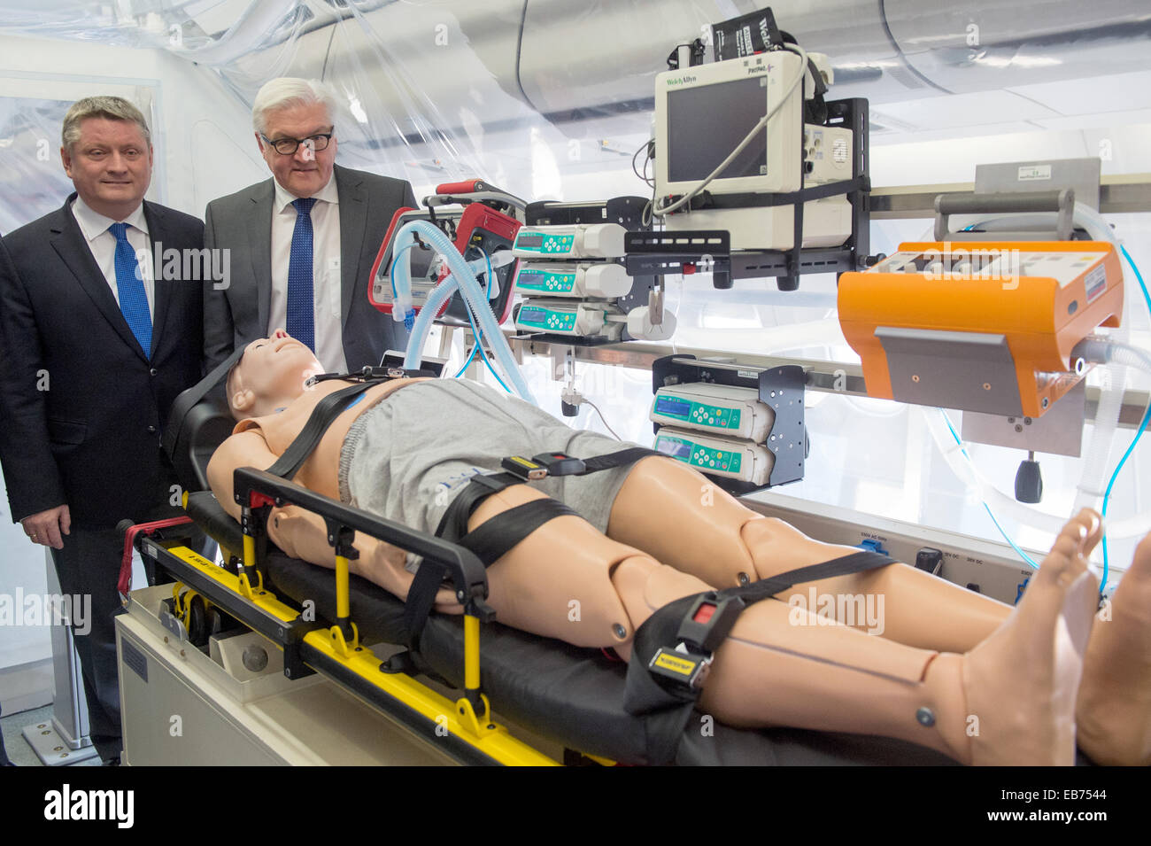 German Foreign Minister Frank-Walter Steinmeier (R) and Health Minister Hermann Groehe tour the 'Robert Koch' evacuation plane at Tegel Airport in Berlin, Germany, 27 November 2014. The Airbus A340 has an isolation unit for highly infectious patients with for example ebola. Photo: MAURIZIO GAMBARINI/dpa Stock Photo