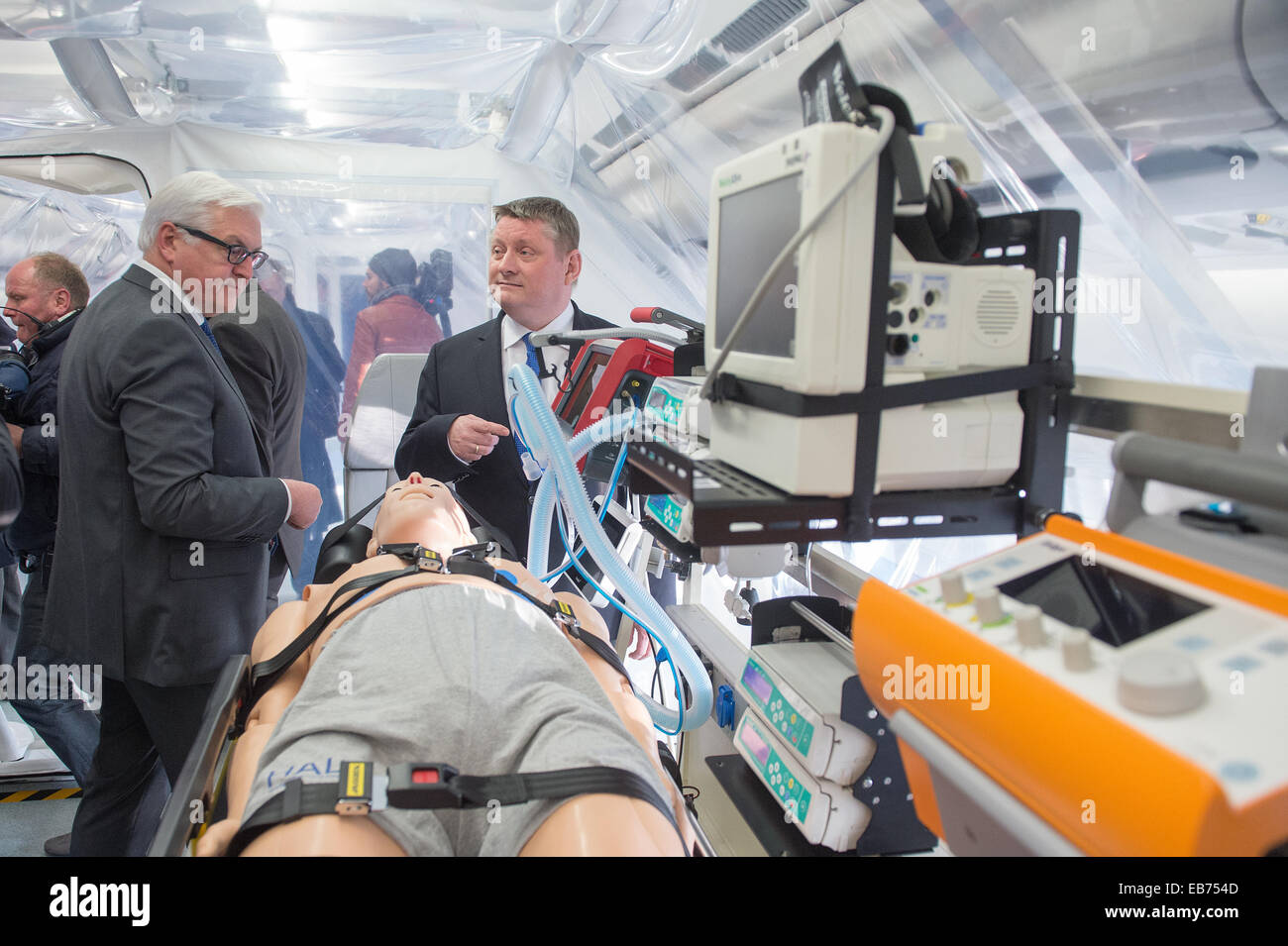 German Foreign Minister Frank-Walter Steinmeier (L) and Health Minister Hermann Groehe tour the 'Robert Koch' evacuation plane at Tegel Airport in Berlin, Germany, 27 November 2014. The Airbus A340 has an isolation unit for highly infectious patients with for example ebola. Photo: MAURIZIO GAMBARINI/dpa Stock Photo