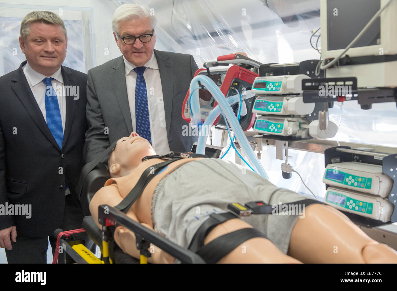 Berlin, Germany. 27th Nov, 2014. German Foreign Minister Frank-Walter Steinmeier (R) and Health Minister Hermann Groehe tour the 'Robert Koch' evacuation plane at Tegel Airport in Berlin, Germany, 27 November 2014. The Airbus A340 has an isolation unit for highly infectious patients with for example ebola. Photo: MAURIZIO GAMBARINI/dpa/Alamy Live News Stock Photo