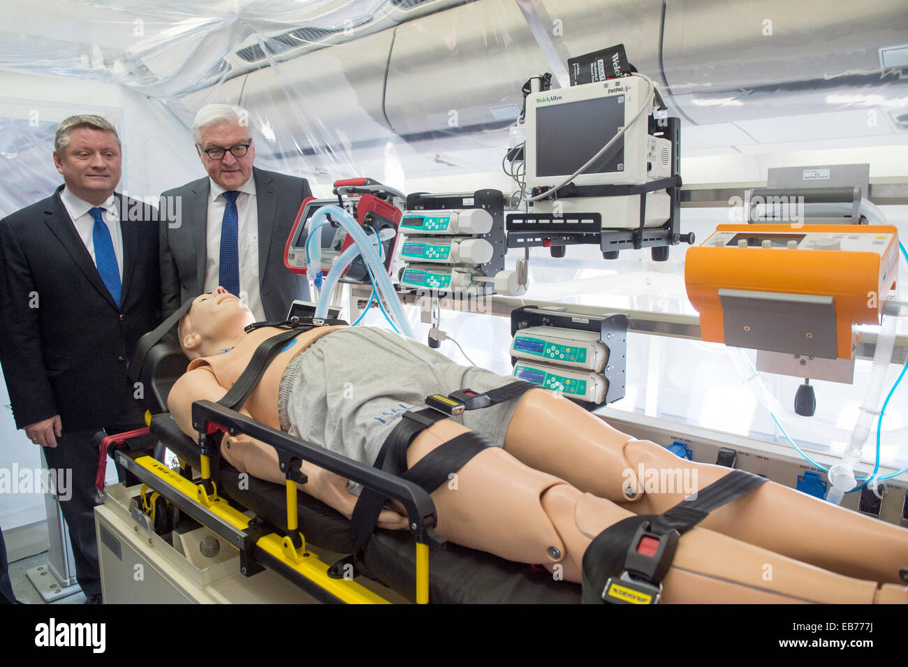 Berlin, Germany. 27th Nov, 2014. German Foreign Minister Frank-Walter Steinmeier (R) and Health Minister Hermann Groehe tour the 'Robert Koch' evacuation plane at Tegel Airport in Berlin, Germany, 27 November 2014. The Airbus A340 has an isolation unit for highly infectious patients with for example ebola. Photo: MAURIZIO GAMBARINI/dpa/Alamy Live News Stock Photo