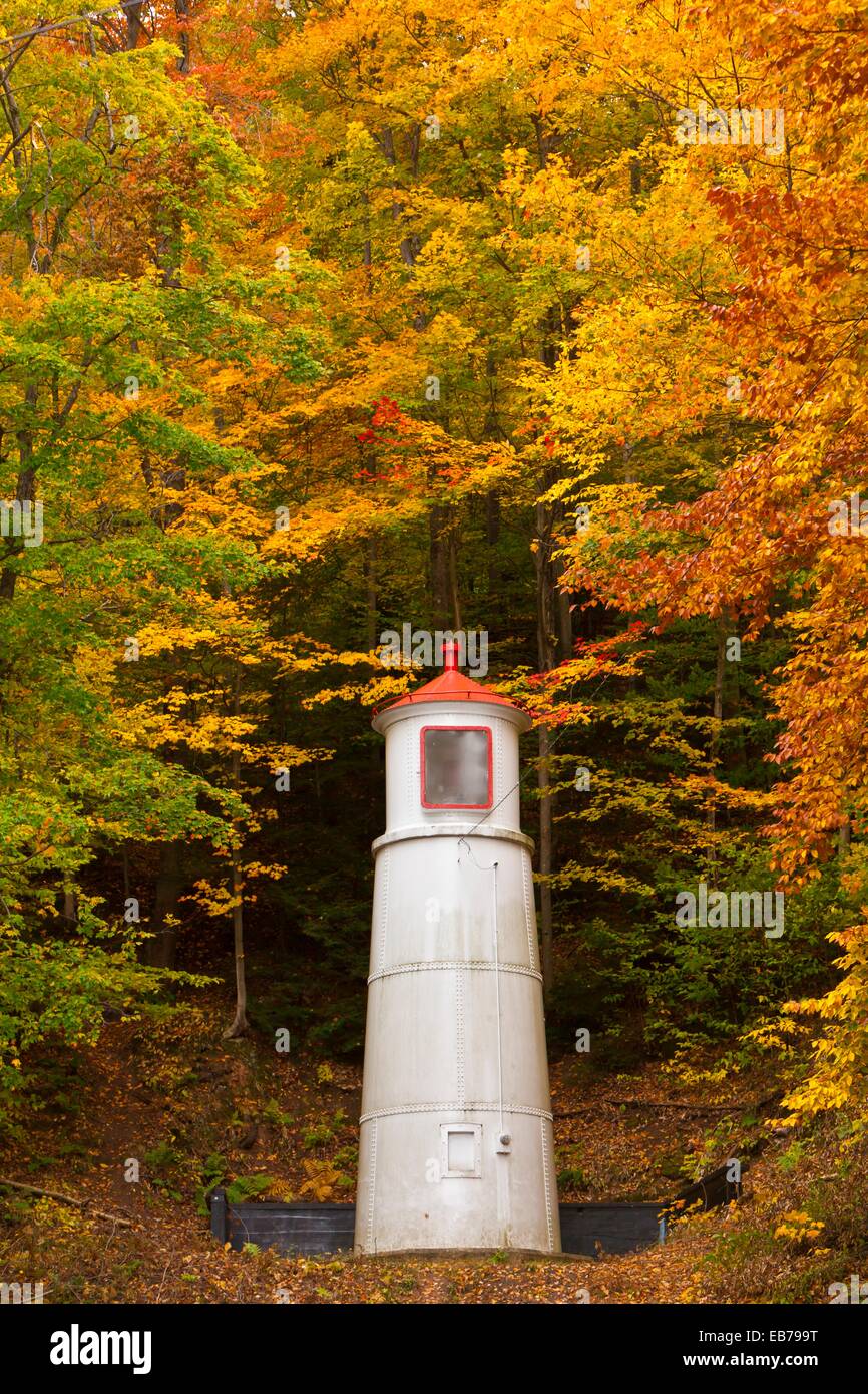 A hillside lighthouse beacon with fall foliage color in Munising
