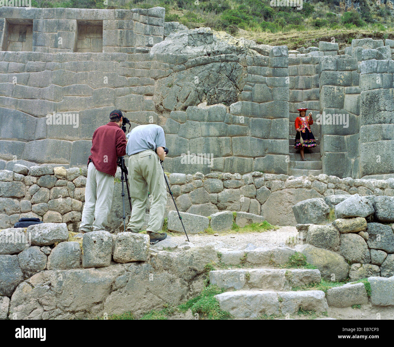 Peru, Tambomachay is an Incan Archaeological Site Near Cusco, Photographer Photographing Women Dressed on Traditional Dress Stock Photo