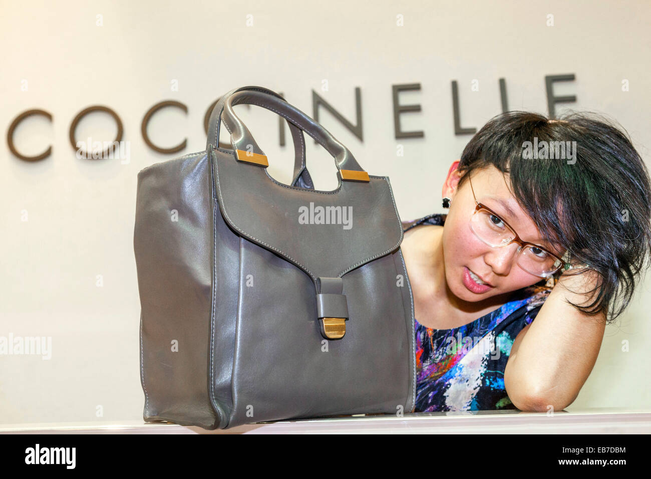 Young Asian woman with a handbag Coccinelle Czech Stock Photo