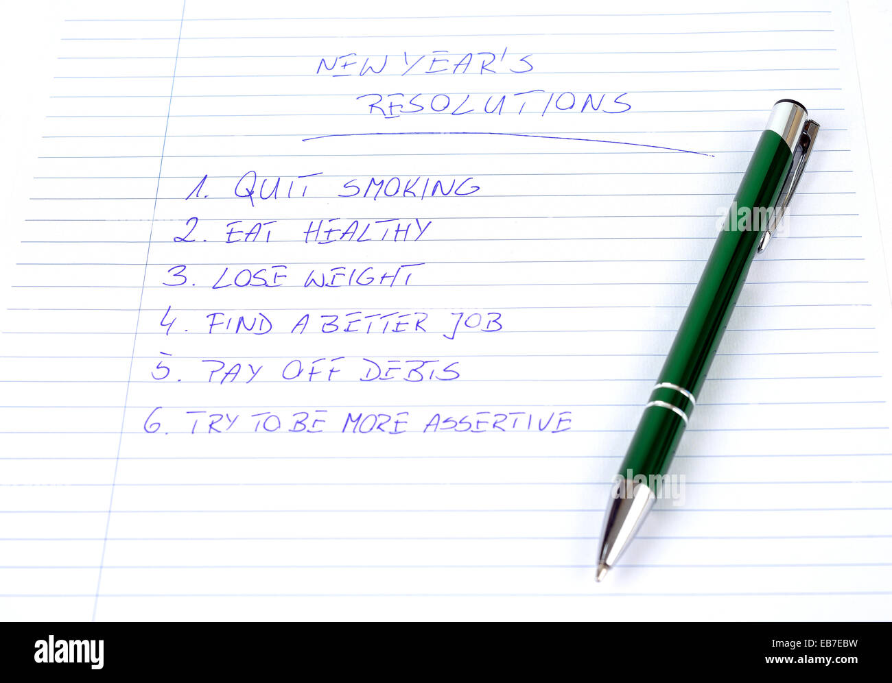 New Year's resolutions listed on the piece of paper Stock Photo