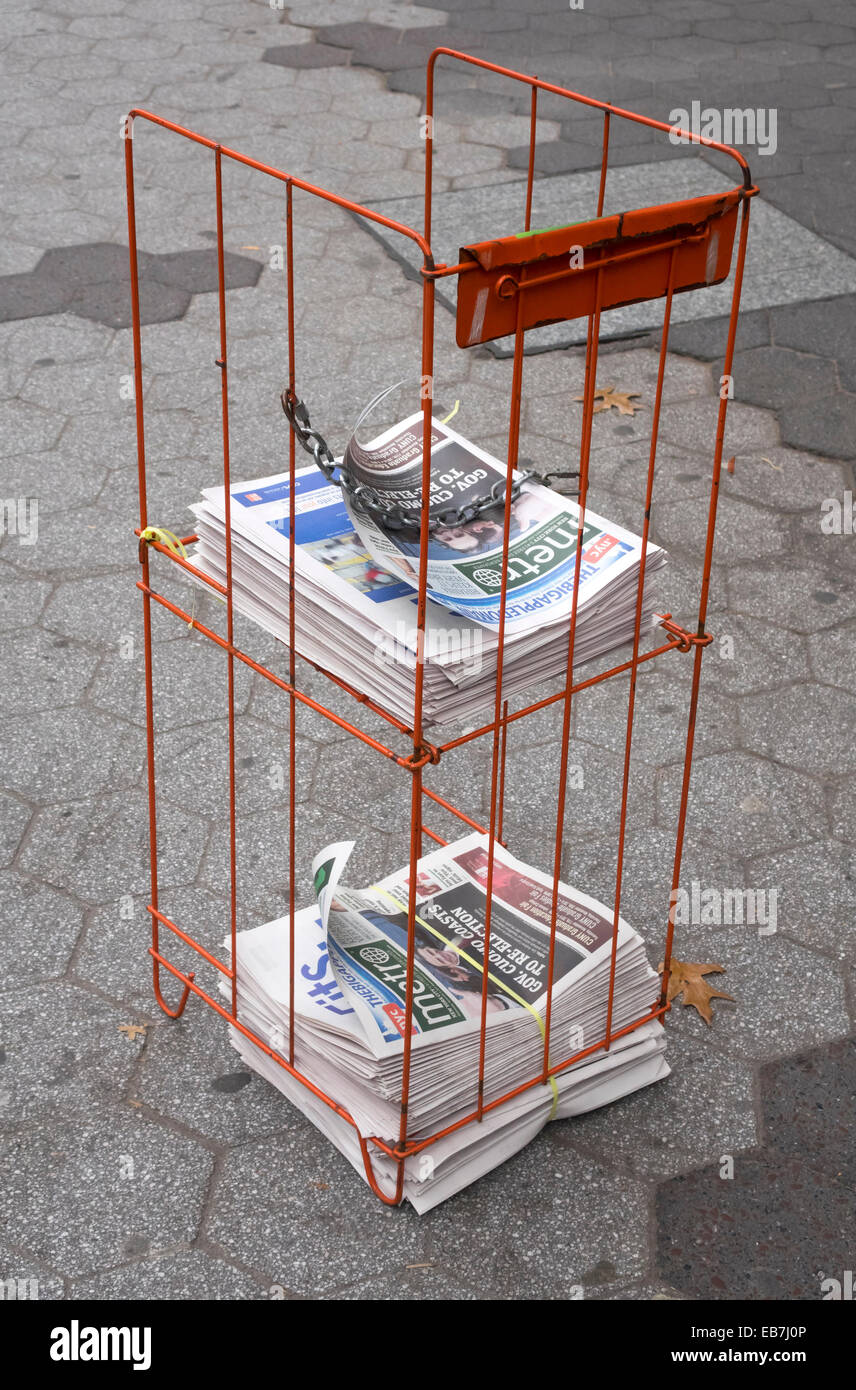 Free newspapers at a small holding stand on Broadway in New York City Stock Photo