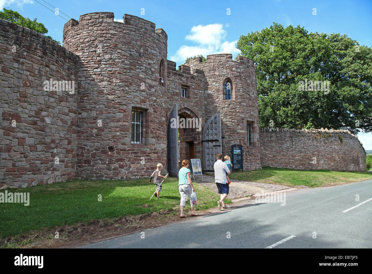A Family With Two Children Walking Towards The Gates And Gateway Of The A Family With Two Children Walking Towards The Gates And Gateway Of The