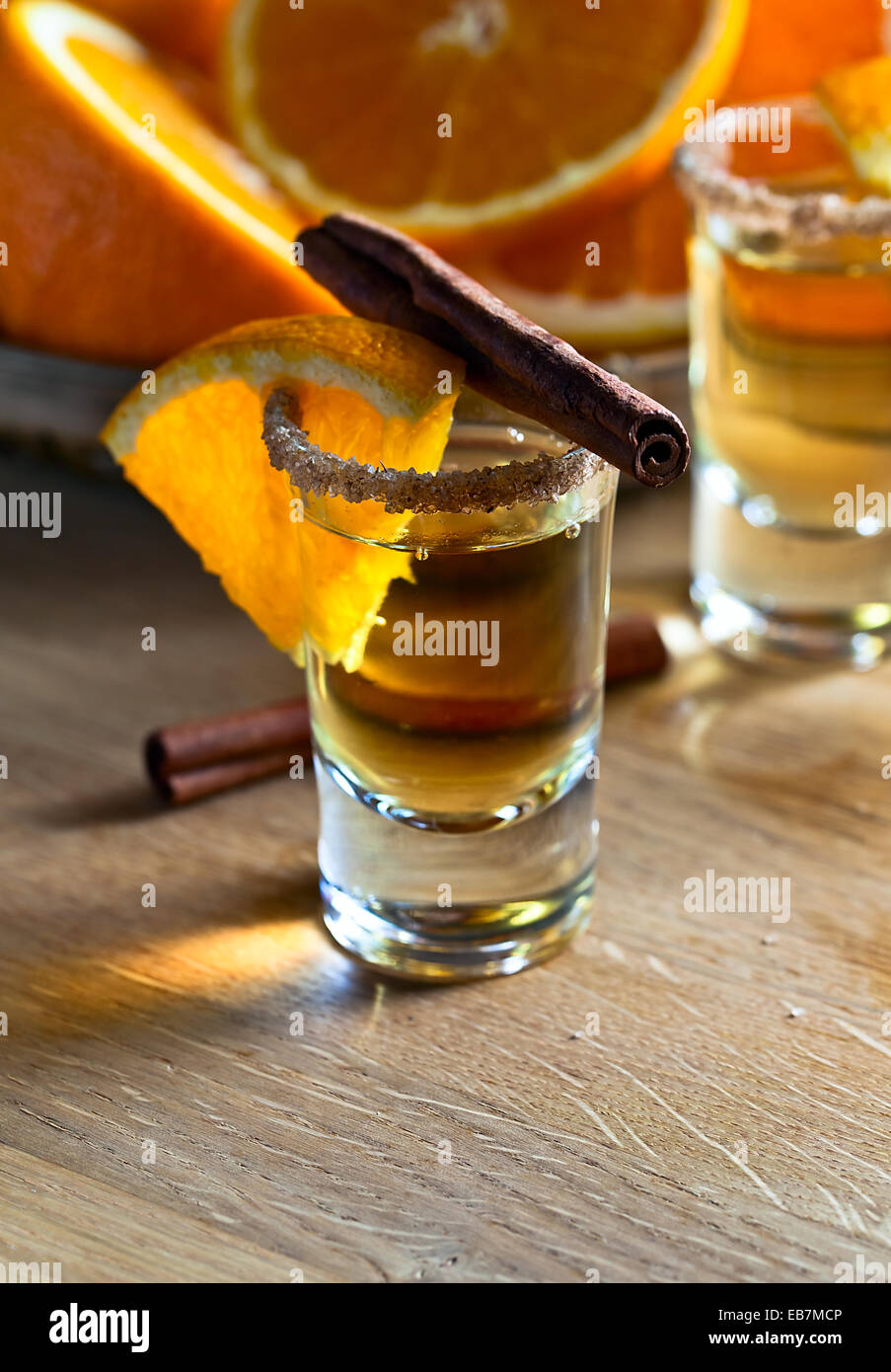 tequila with orange and cinnamon on wooden table Stock Photo Alamy