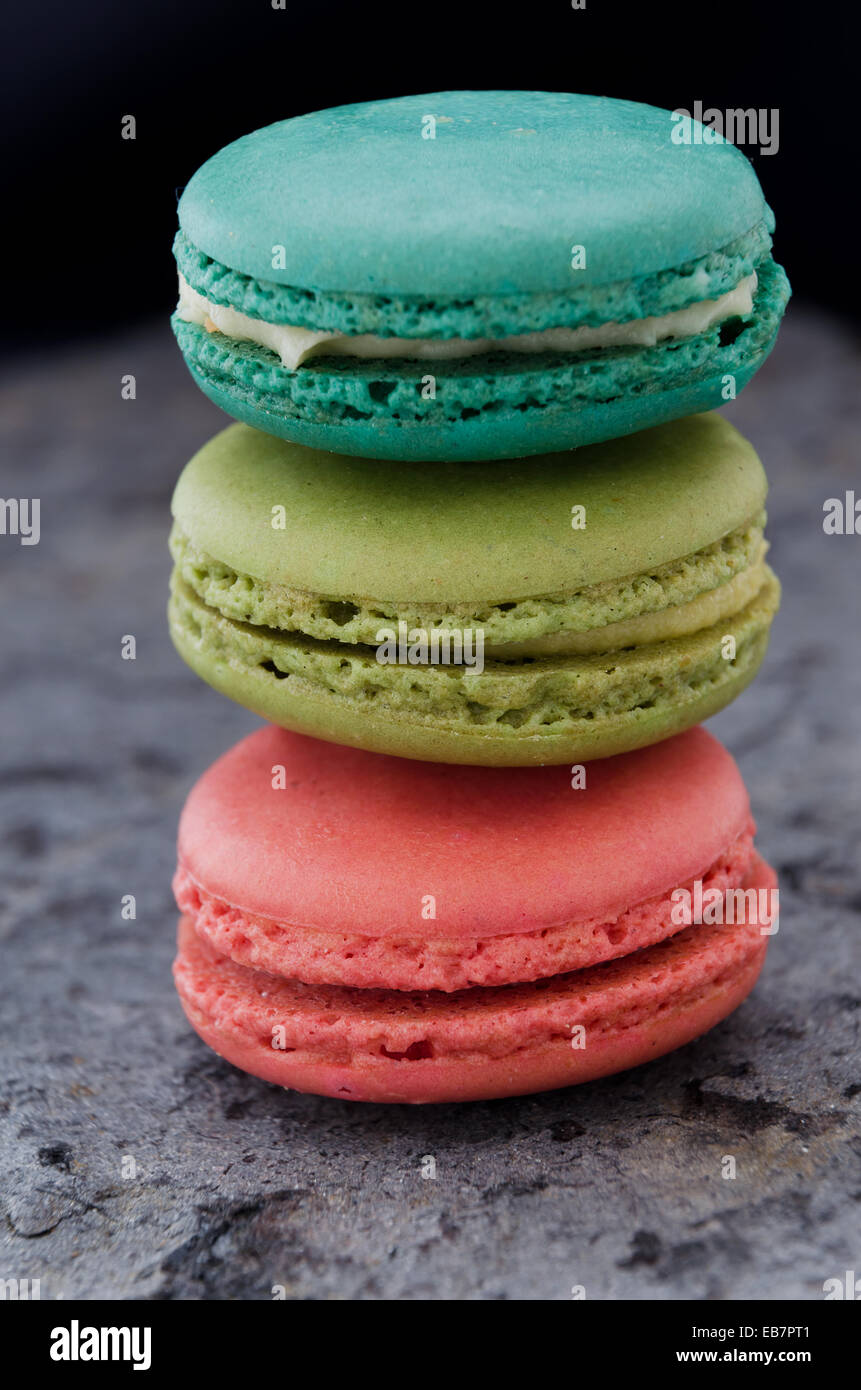 Stack of macaroons biscuits over gray stone texture Stock Photo - Alamy