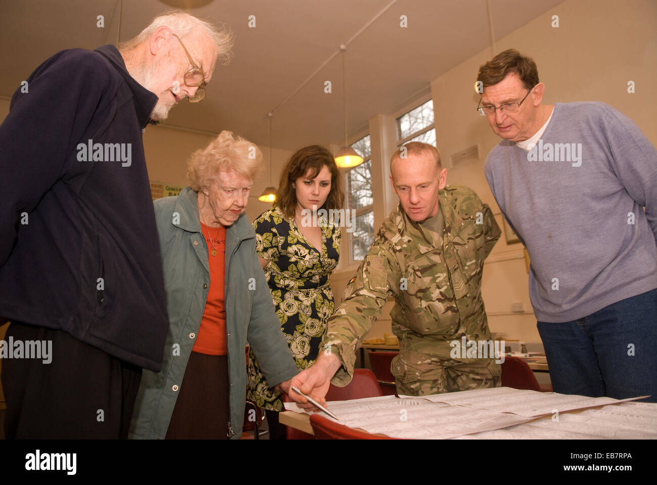 People perusing old maps at a heritage open day at local arts centre, Bordon, Hampshire, UK. Stock Photo