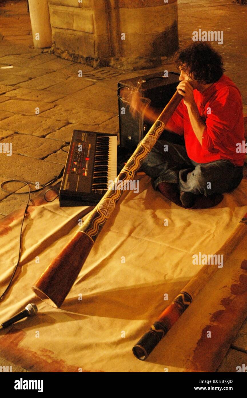Bologna, Italy a street musician playing didgeridoo in Piazza Maggiore