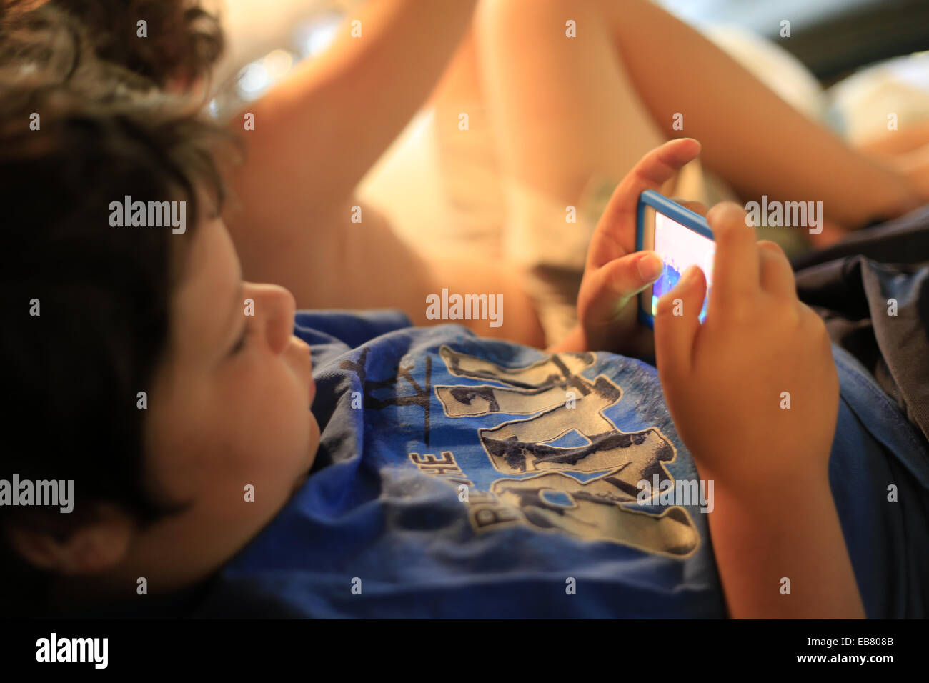 A 9 year old boy playing games on an apple ipod touch electronic device  Stock Photo - Alamy