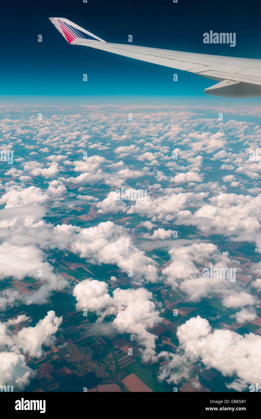 View of  land, fields, and clouds from above Stock Photo