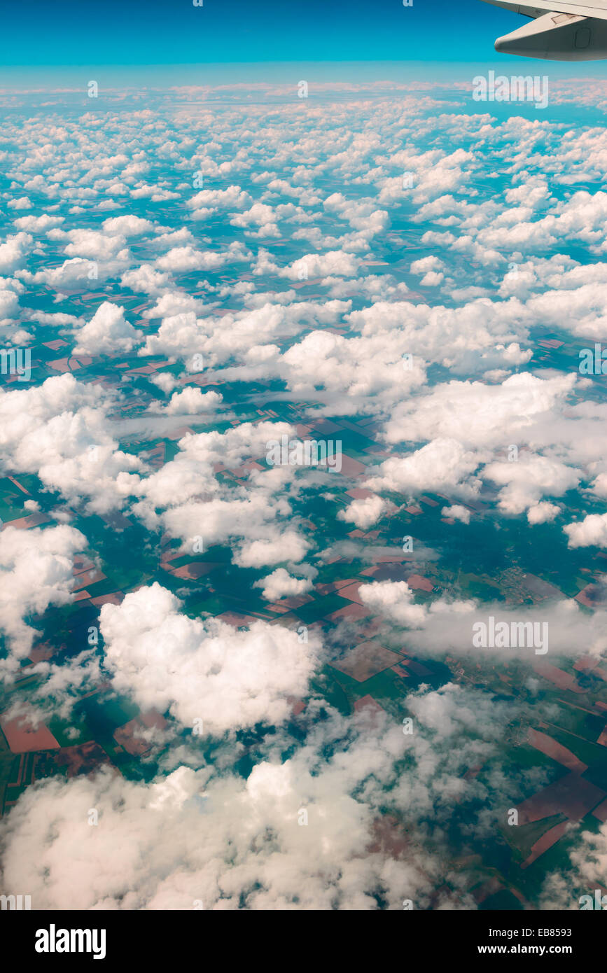 View of  land, fields, and clouds from above Stock Photo