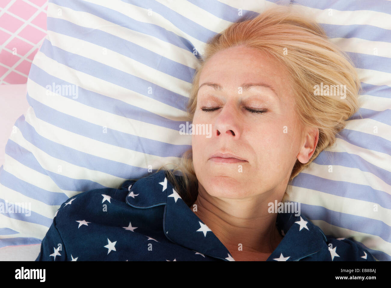 Mature woman sleeping in bed Stock Photo Alamy