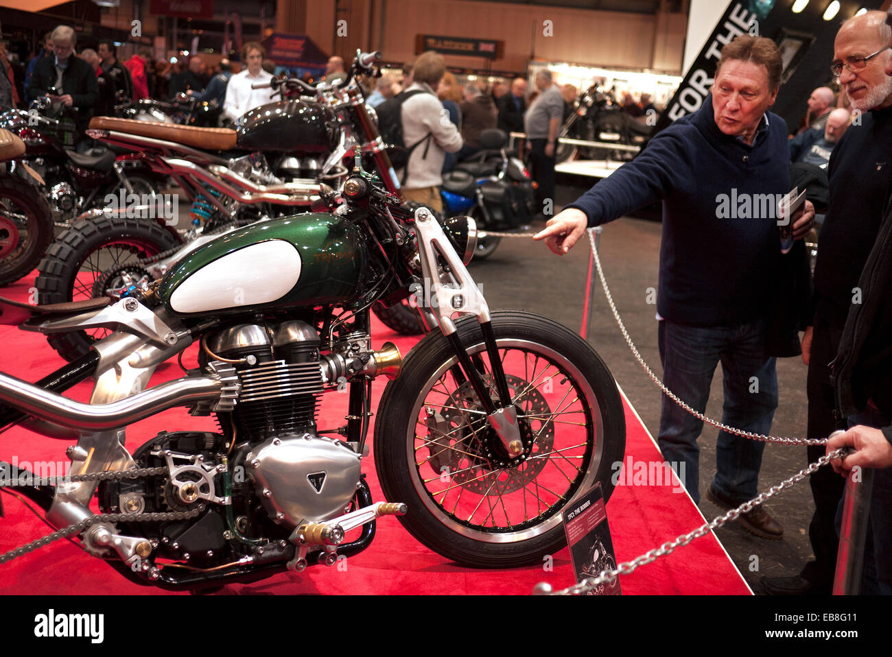 Visitors to the Motorcycle Live show at Birmingham's NEC, take a look at a custom Triumph motorcycle. Stock Photo