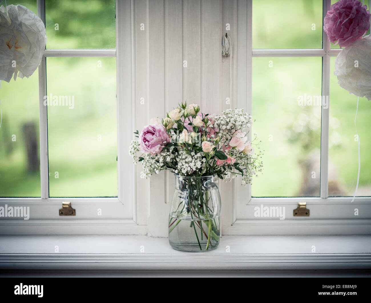wedding flowers in a window with pink and yellow flowers Stock Photo