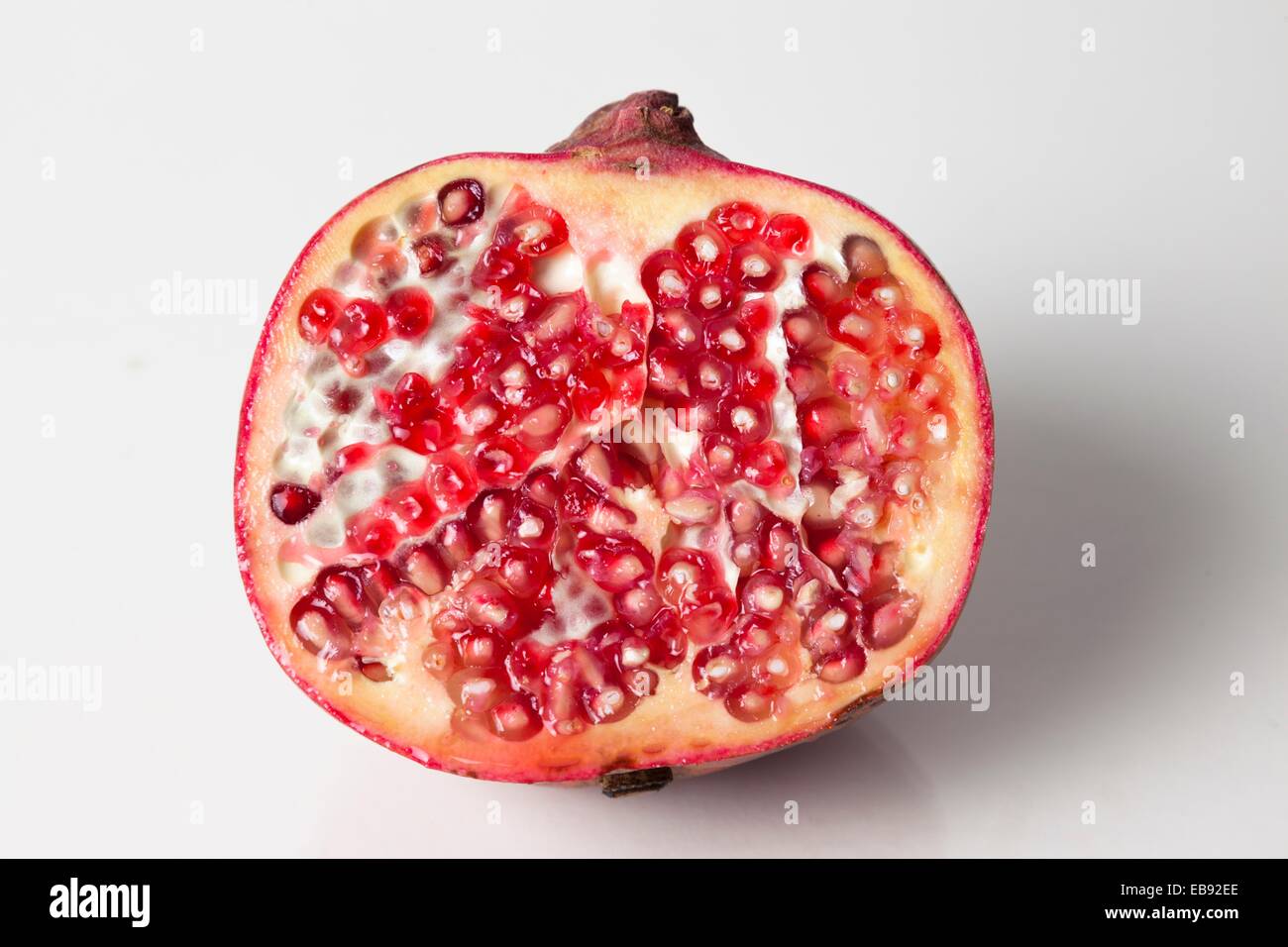 Halved pomegranite on white background Stock Photo Alamy