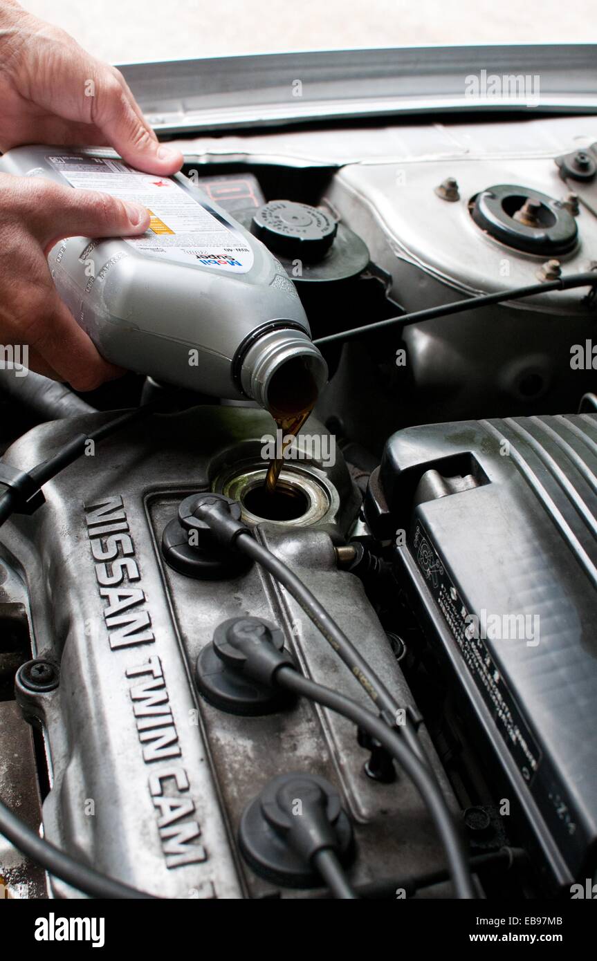 Topping up car engine oil Stock Photo Alamy