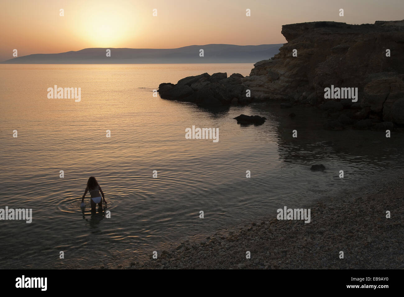 Woman in bikini going to have a swim, Koufonissi, Cyclades Islands