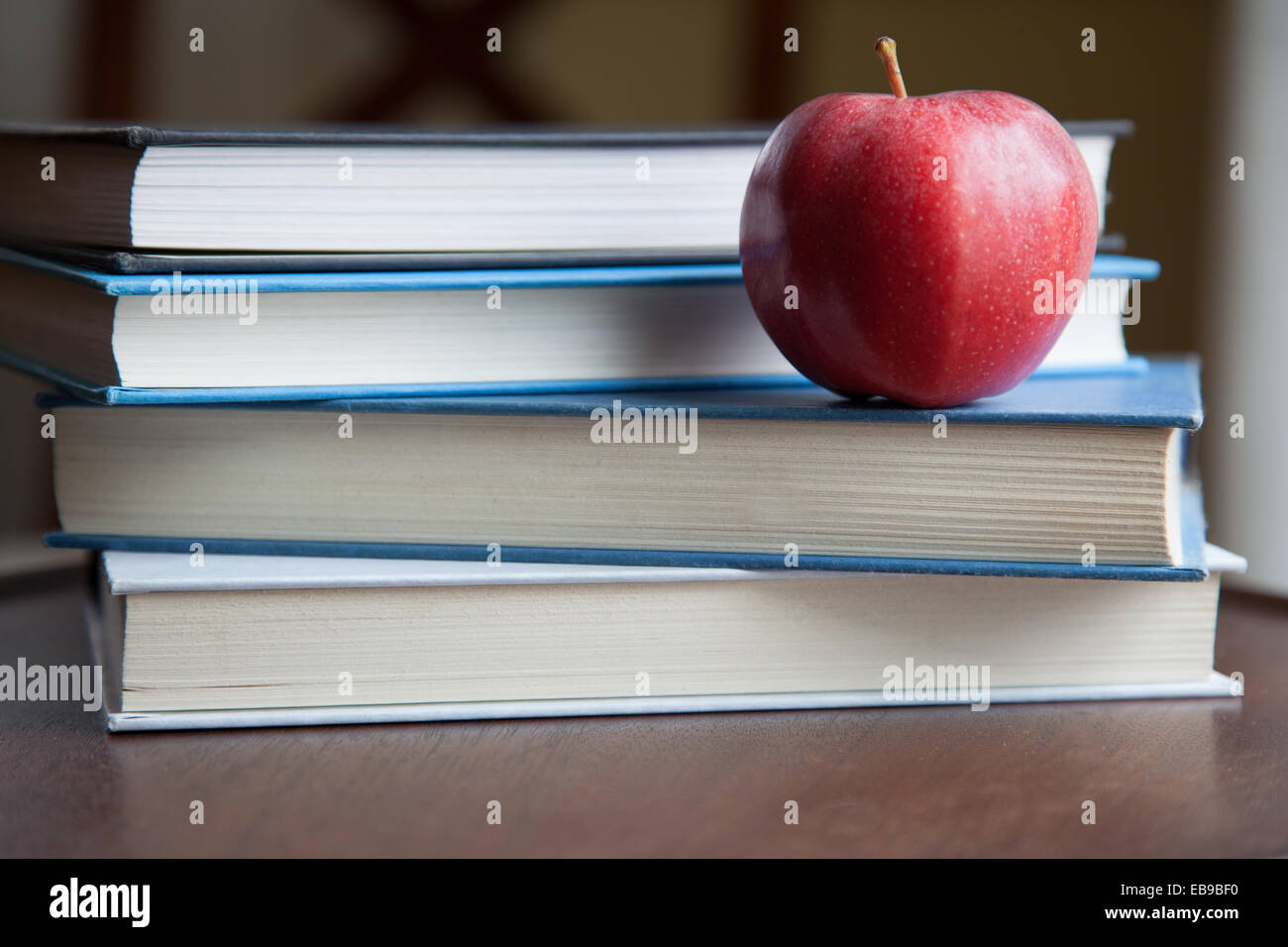 An apple sitting on text books. Stock Photo