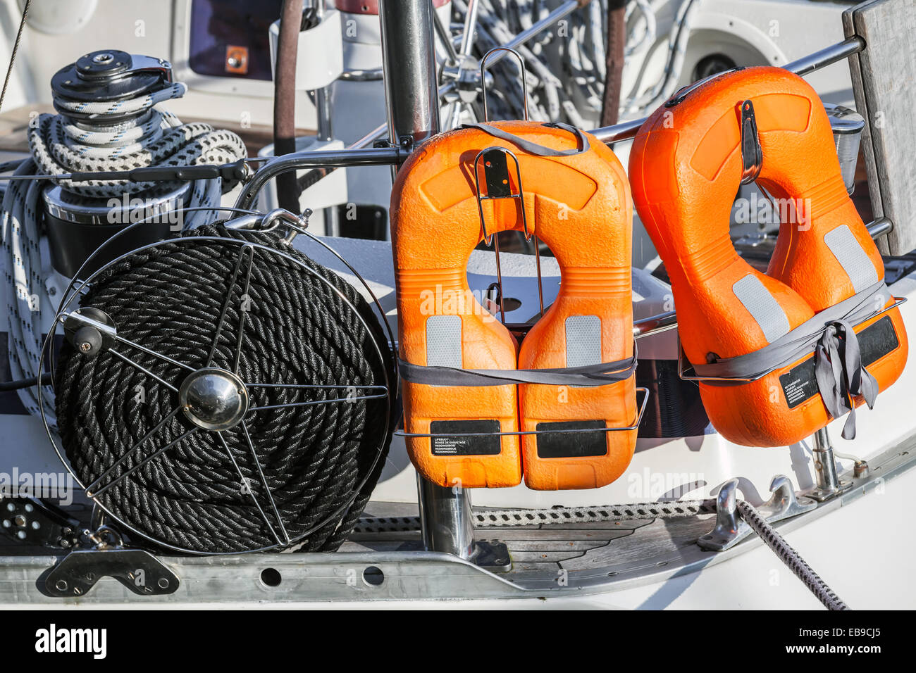 Orange lifebuoys and black rope, safety equipment of modern yacht Stock Photo