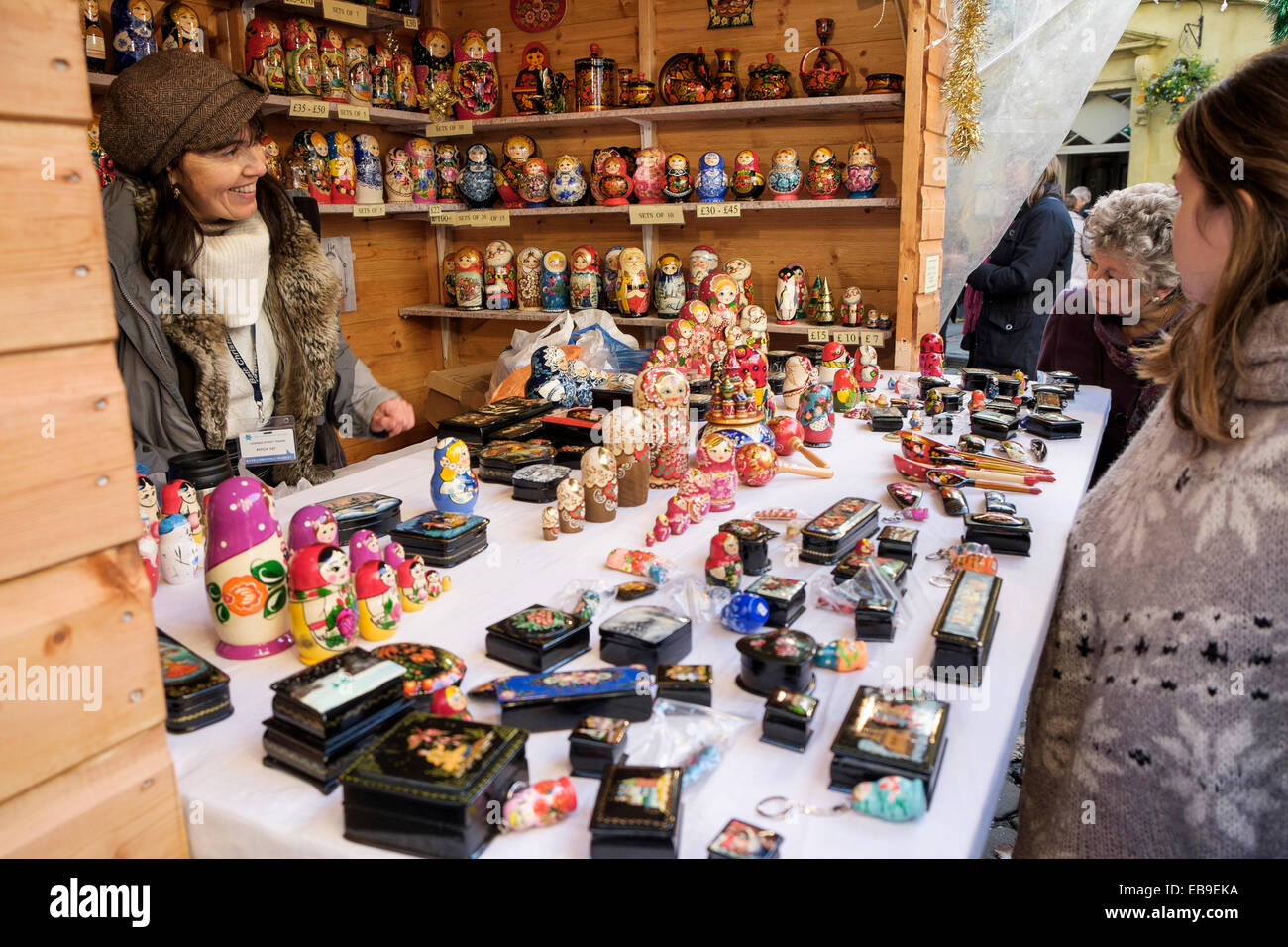 Bath, UK, 27th November 2014. Members of the public are pictured viewing nesting Russian dolls being sold on a market stall on the opening day of the Bath Christmas market. Credit:  lynchpics/Alamy Live News Stock Photo
