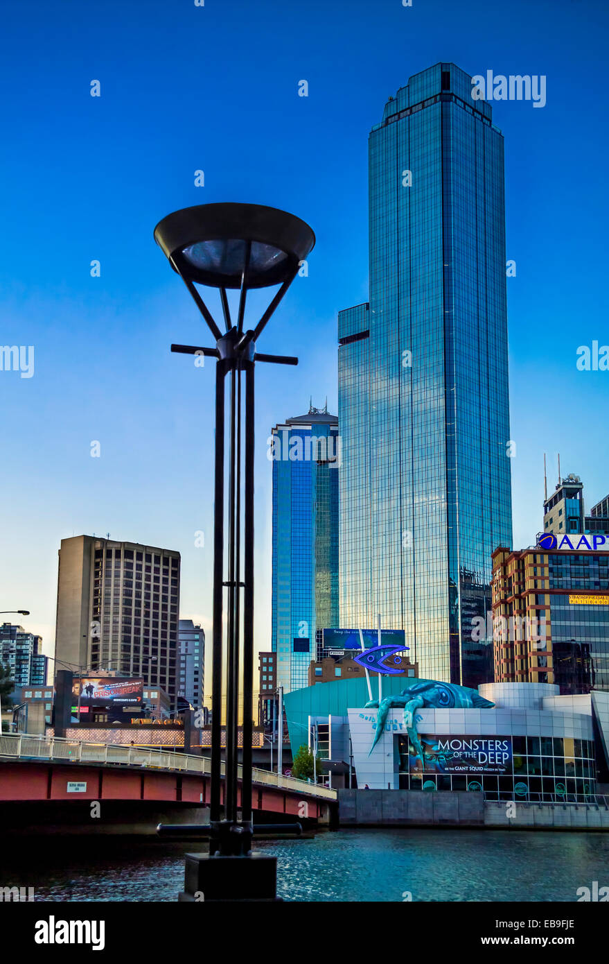 Colourful dusk scene taken from Southbank waterfront looking across the Yarra River  Aquarium, glass skyscrapers Melbourne CBD Stock Photo