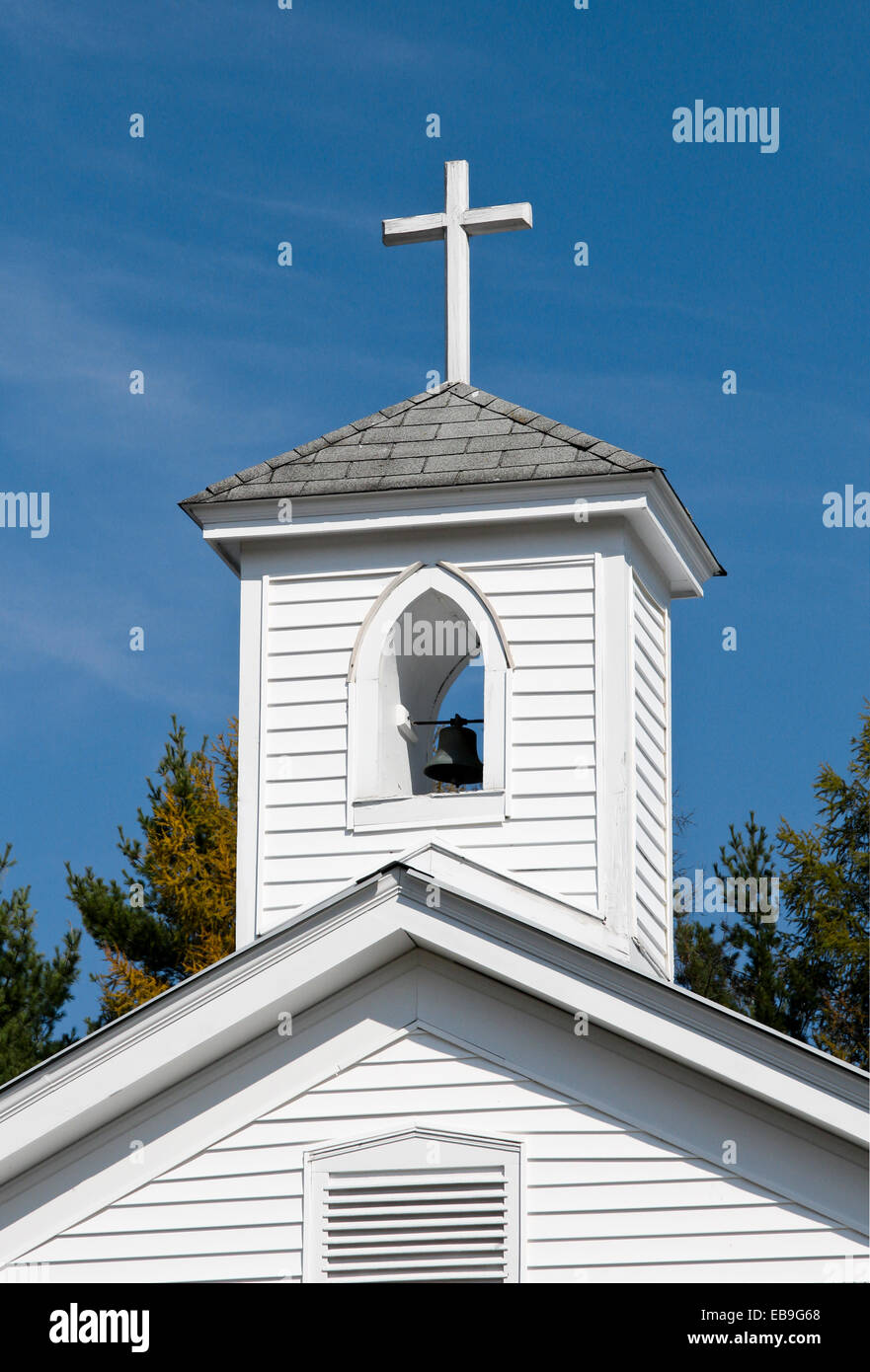 Church bell tower with bell and cross. Stock Photo