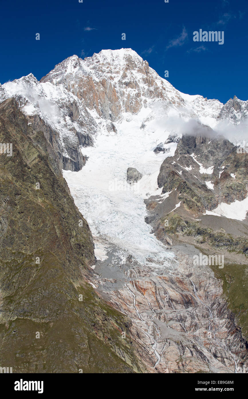 The rapidly retreating Glacier De La Lex Blanche on the Aiguille De Tre La Tete in the Italian Alps on the Tour Du Mont Blanc. Stock Photo