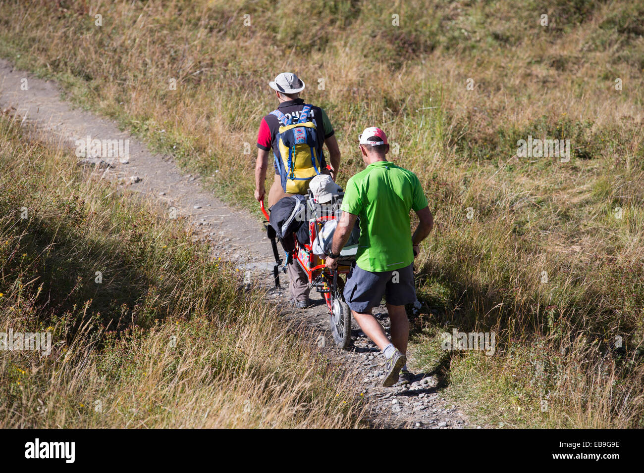 A disabled person being taken into the mountains on a specialised mobility bike above Courmayeur, Italy. Stock Photo