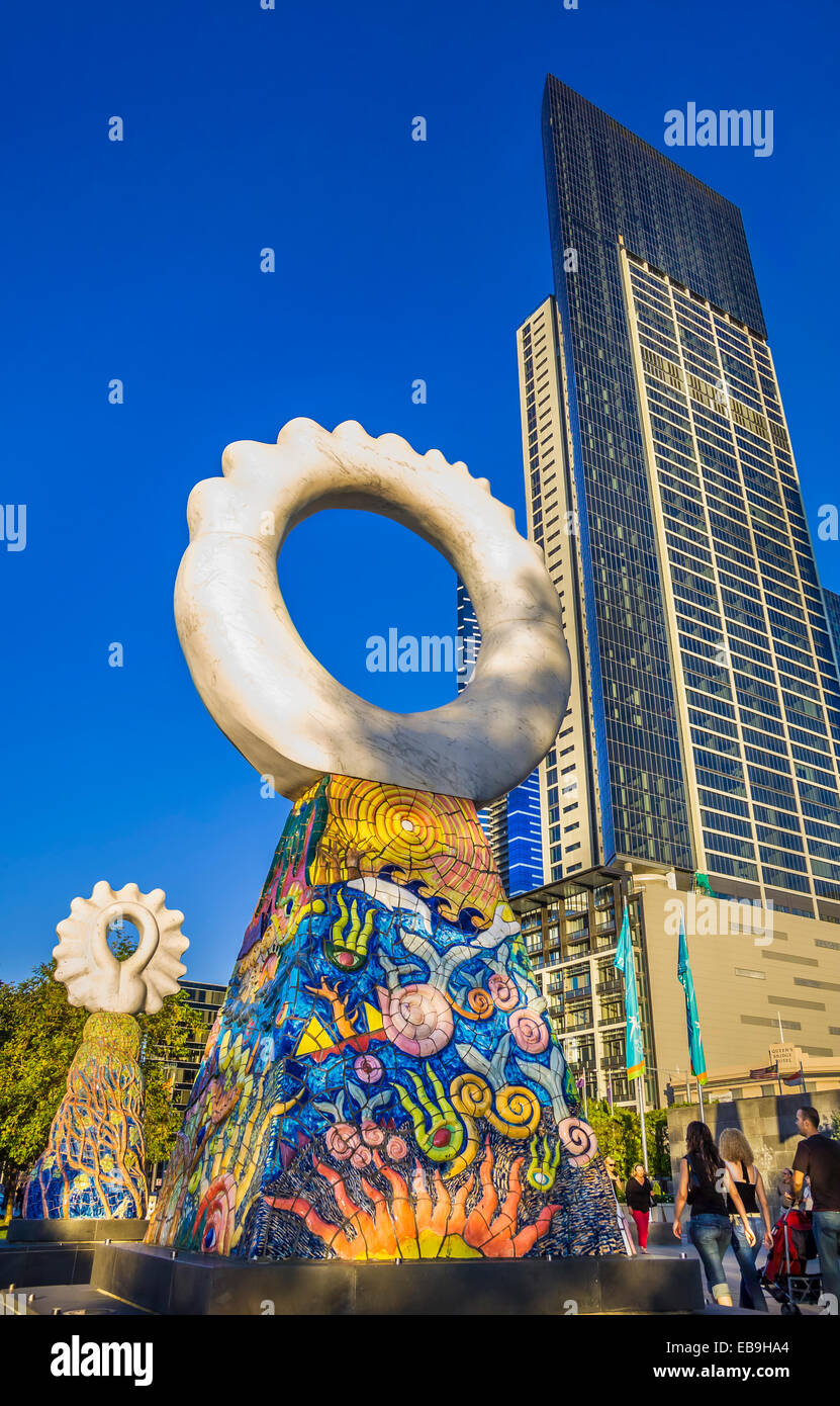 'The Guardians' sculpture by Simon Rigg, against tall skyscrapers