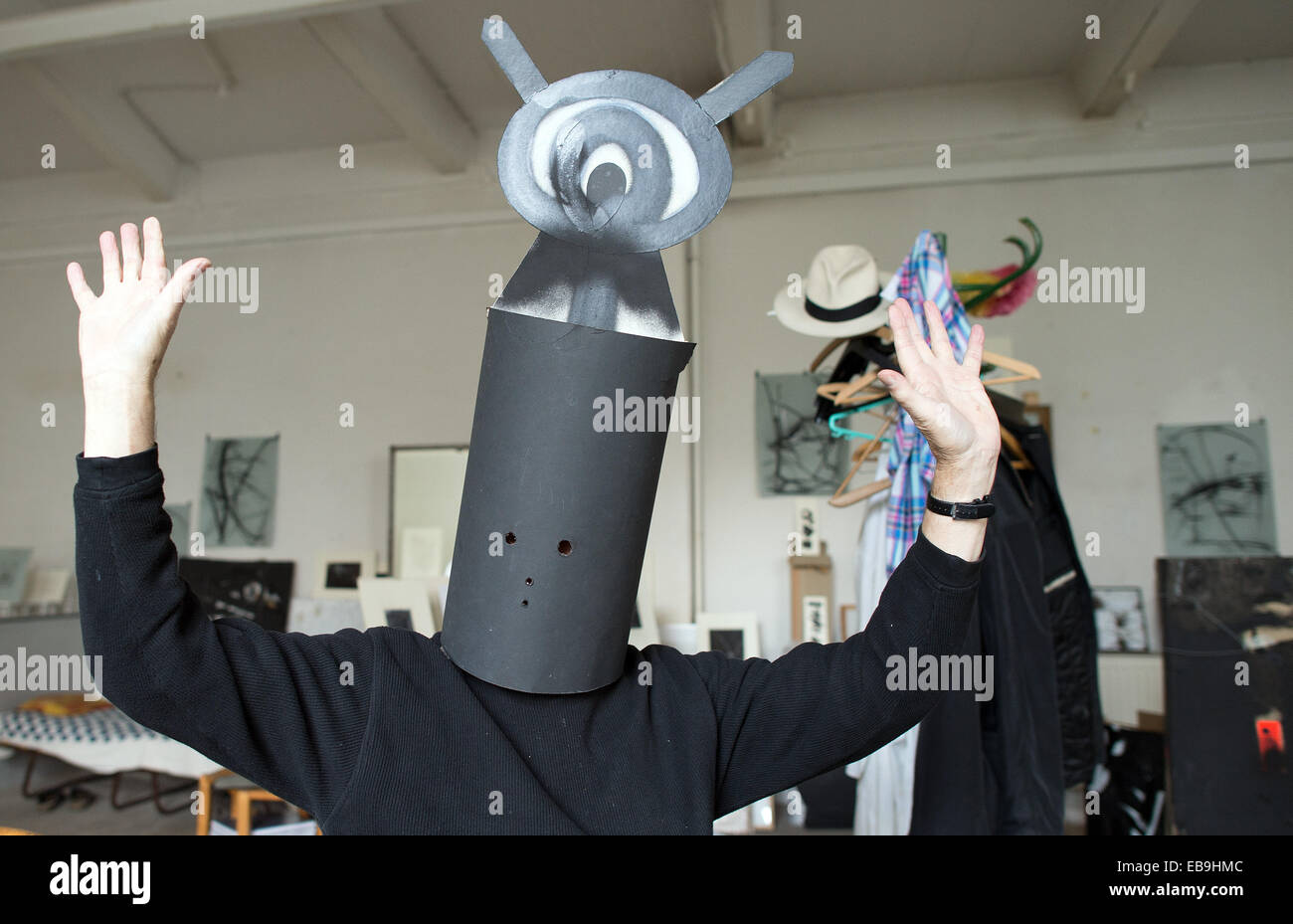 Duesseldorf, Germany. 21st Nov, 2014. Artist Harald Naegeli stands with his magic hat over his head in his studio in Duesseldorf, Germany, 21 November 2014. The artist, who is famous for his graffiti in Zurich in the 1970's, will turn 75 on 04 December 2014. Photo: FEDERICO GAMBARINI/dpa/Alamy Live News Stock Photo